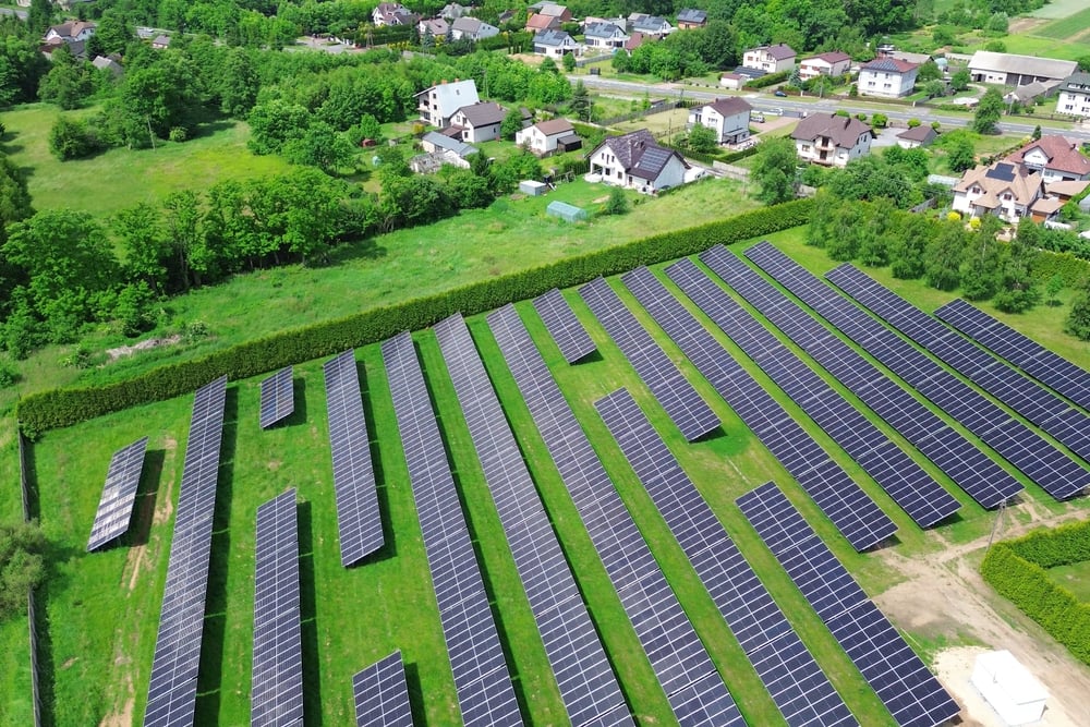 Solar panels near a rural community at sunset